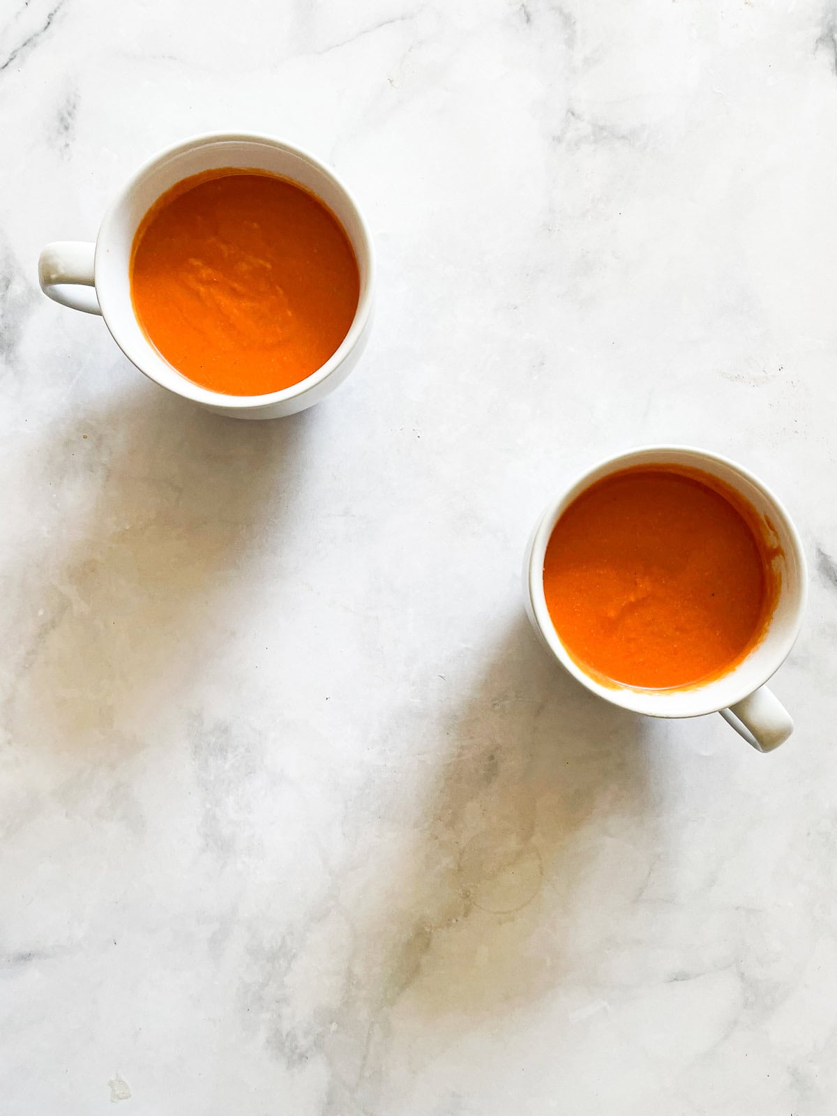 Two cups of vegetarian cream of tomato soup.