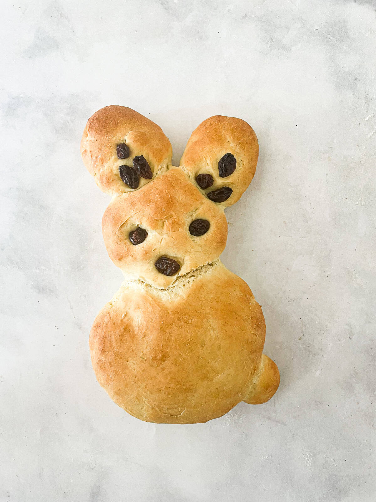 Kids love bunny bread that stars an easy, yeast-based dough that's simple to mix, fun to knead, and bakes up into the cutest golden bunnies. A raisin-decorated bunny bread.