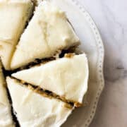 A mini carrot cake is cut into slices.