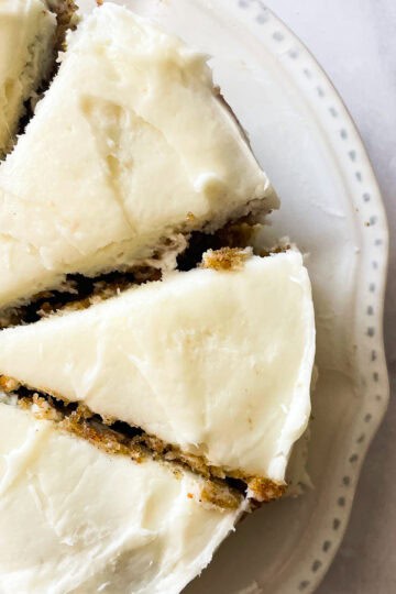 A mini carrot cake is cut into slices.
