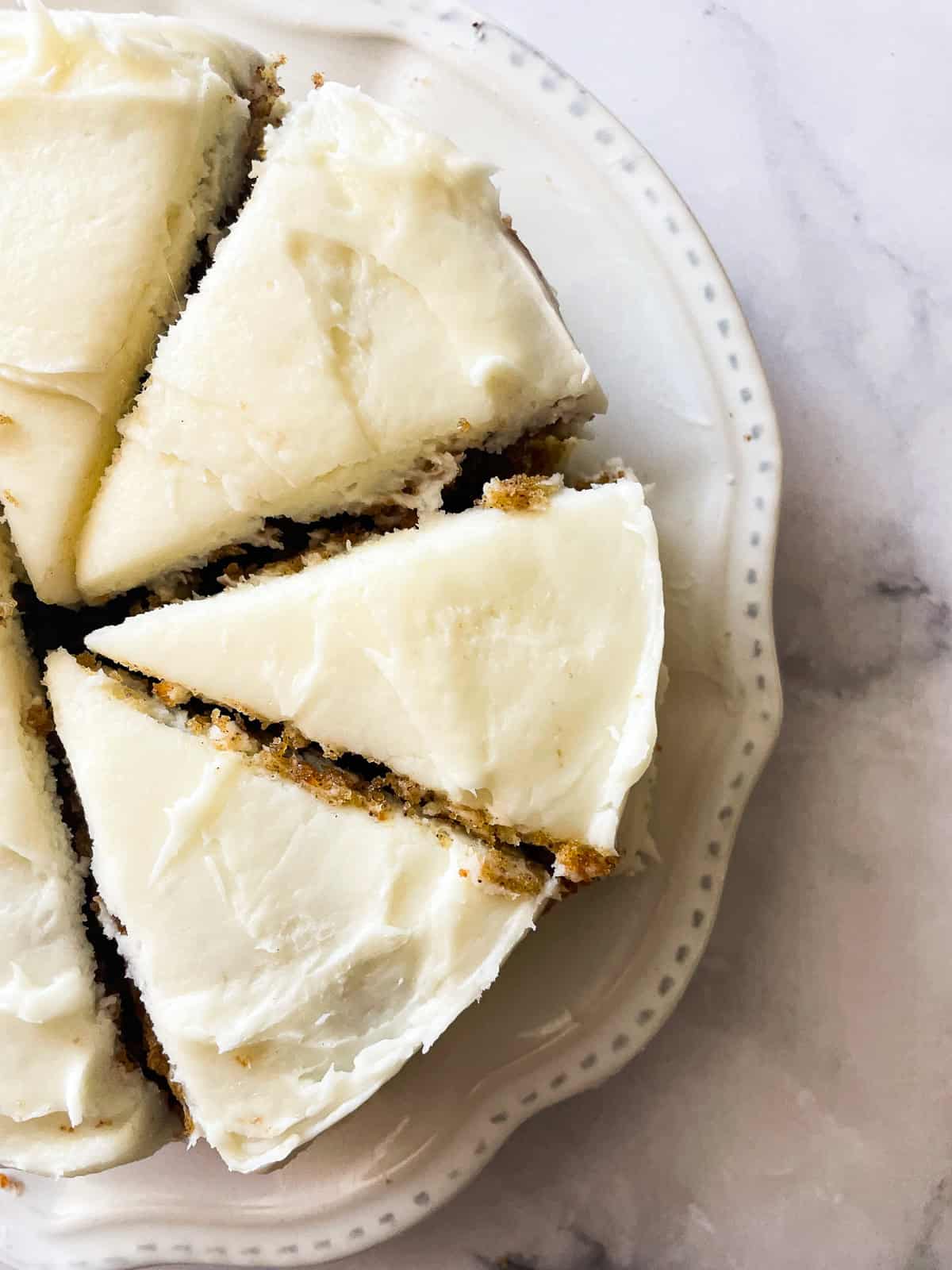 This mini carrot cake is everything you adore about carrot cake but smaller! You'll love the tender crumb and tangy cream cheese frosting. A mini carrot cake is cut into slices.