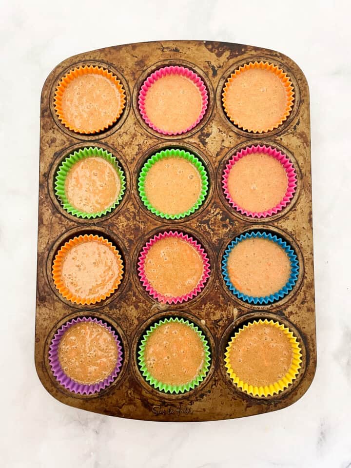 Carrot cake cupcakes batter in a muffin tin.