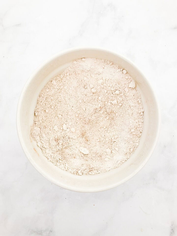 The dry mix for gluten free carrot cake cupcakes in a bowl.