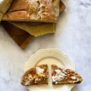 A loaf of porridge bread with a slice of bread.