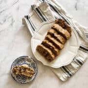 A plate of sliced banana bread on top of a napkin.