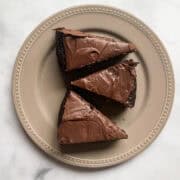 Three slices of chocolate teff cake on a plate.