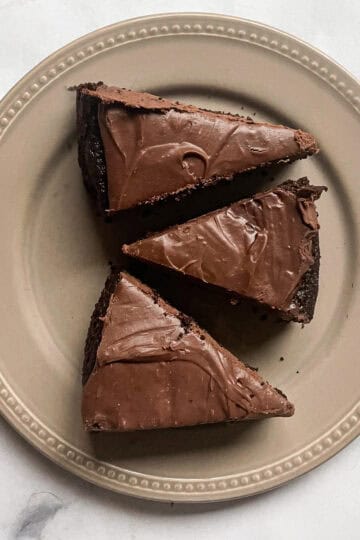 Three slices of chocolate teff cake on a plate.