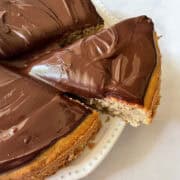 A slice of gluten free banana cake is cut from the cake.