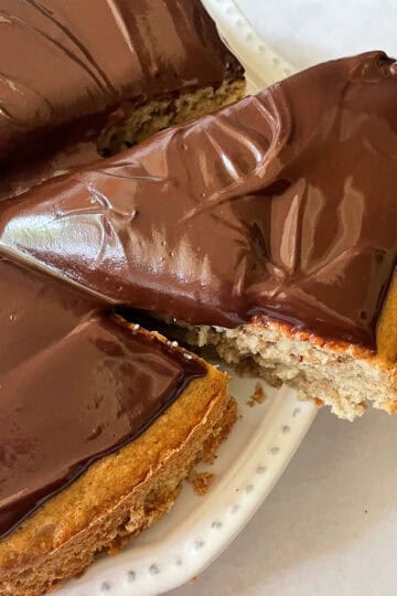 A slice of gluten free banana cake is cut from the cake.