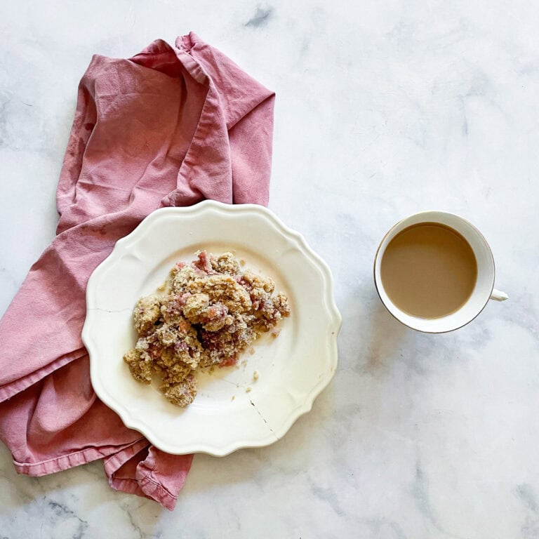 A serving of gluten free rhubarb crumble on a plate.