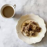 A serving of strawberry rhubarb crumble and a cup of coffee.