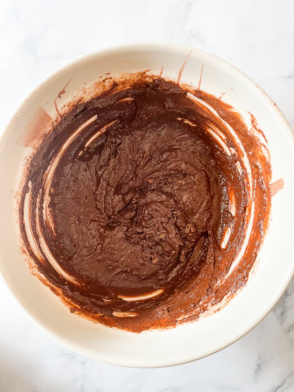 Chocolate teff cake batter in a bowl.