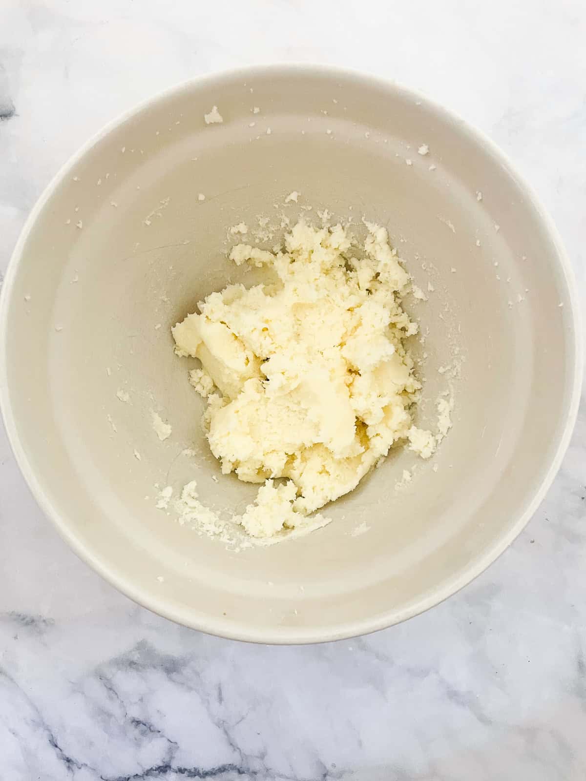 Butter and sugar creamed in a bowl.