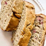Three slices of gluten free rhubarb banana bread on a plate.