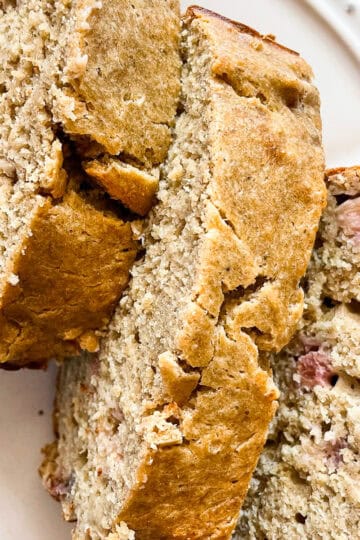 Three slices of gluten free rhubarb banana bread on a plate.