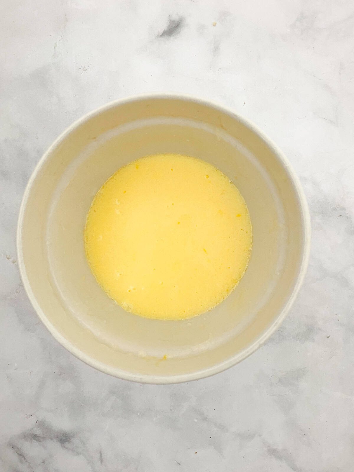Wet mix for gluten free strawberry muffins in a bowl.