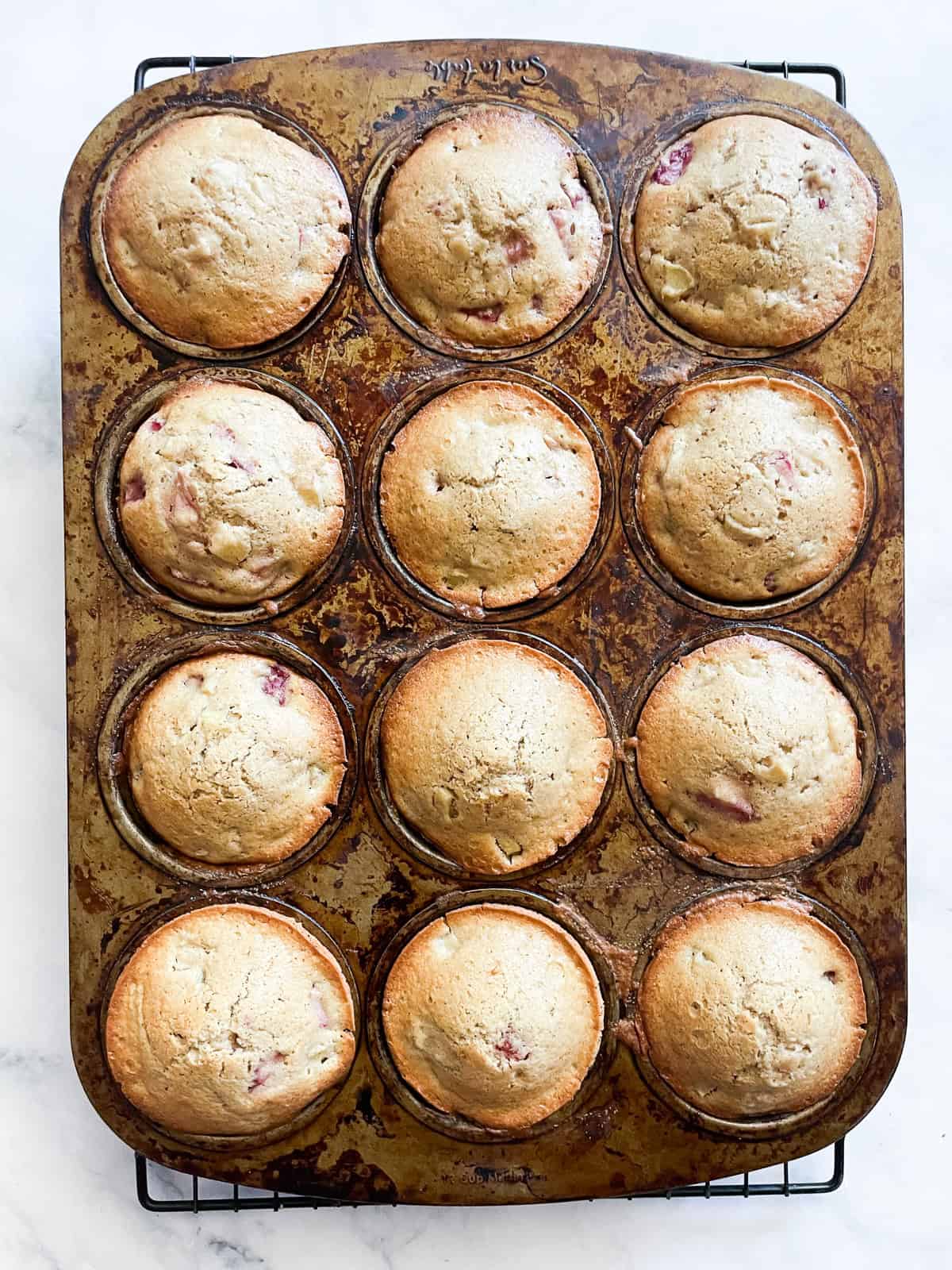 Gluten free strawberry muffins in the tin after being baked.