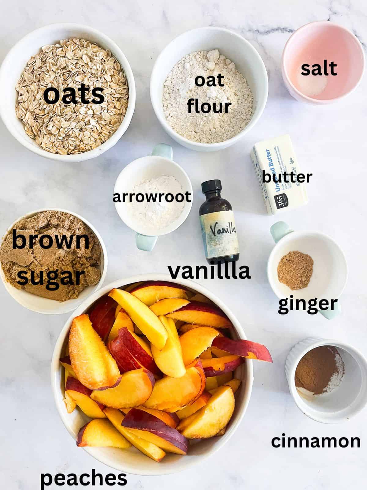 This gluten-free peach crisp stars juicy fresh peaches tucked under a rich toasted oat topping. Must be served with vanilla ice cream! The ingredients for gluten-free peach crisp are text-labeled.