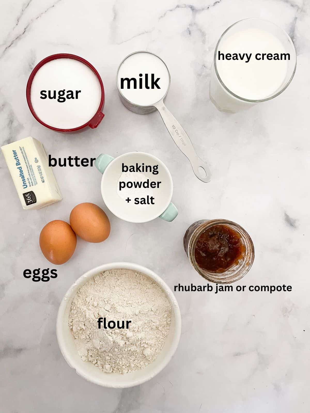 A soft and buttery rhubarb cake recipe with tender cake layers that sandwich tangy-sweet rhubarb compote and fluffy whipped cream. Ingredients for a rhubarb cake recipe with whipped cream are text labeled.