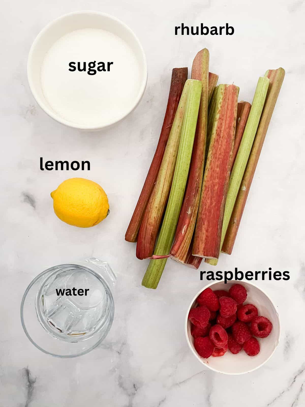 A pretty raspberry rhubarb jam that marries seasonal fresh berries with tart rhubarb to make a silky smooth, uniquely flavored jam. Ingredients for raspberry rhubarb jam are text-labeled.