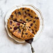 A cake server lifts out a piece of cherry torte.