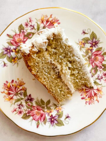 A floral plate with a slice of gluten free rhubarb cream cake.