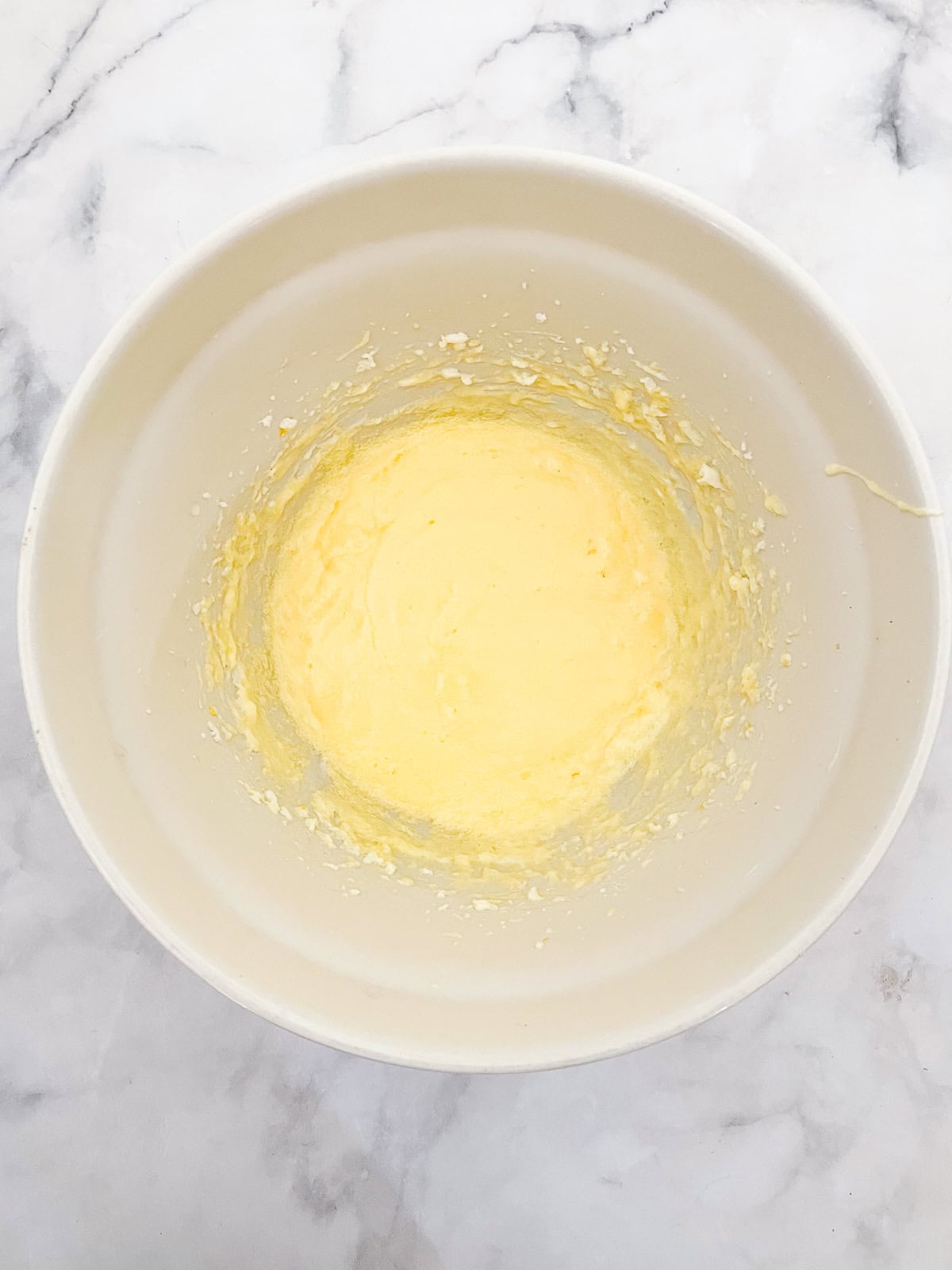 This rustic gluten-free cherry torte tucks sweet, fresh cherries into a tender, buttery cake made with just two simple gluten-free flours. Sugar, butter, and eggs are beaten together in a bowl.