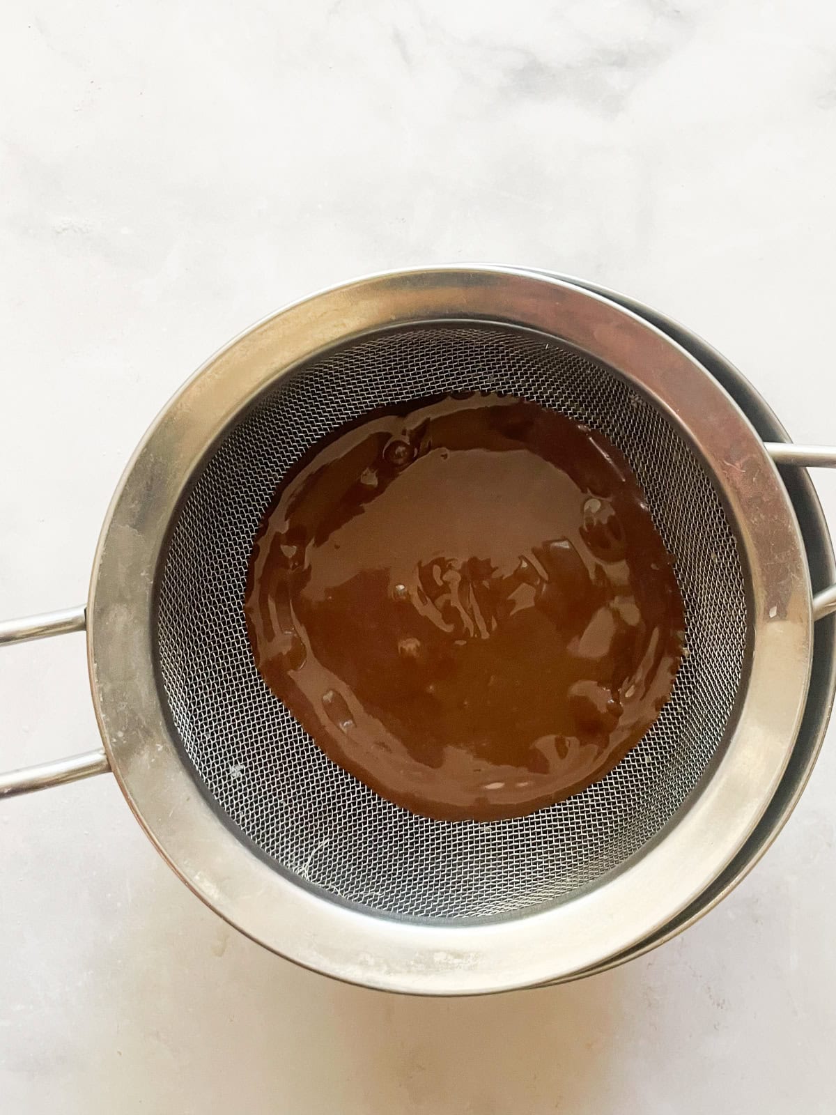 Silky smooth and wonderfully rich gluten free chocolate pudding comes together easily to make a celebration-worthy dessert. Chocolate pudding is strained through a sieve.
