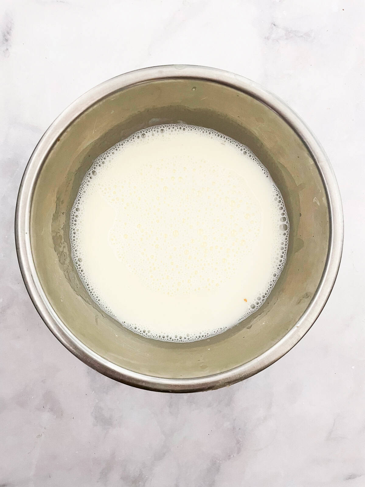 Silky smooth and wonderfully rich gluten free chocolate pudding comes together easily to make a celebration-worthy dessert. A bowl of hot cream and sugar.