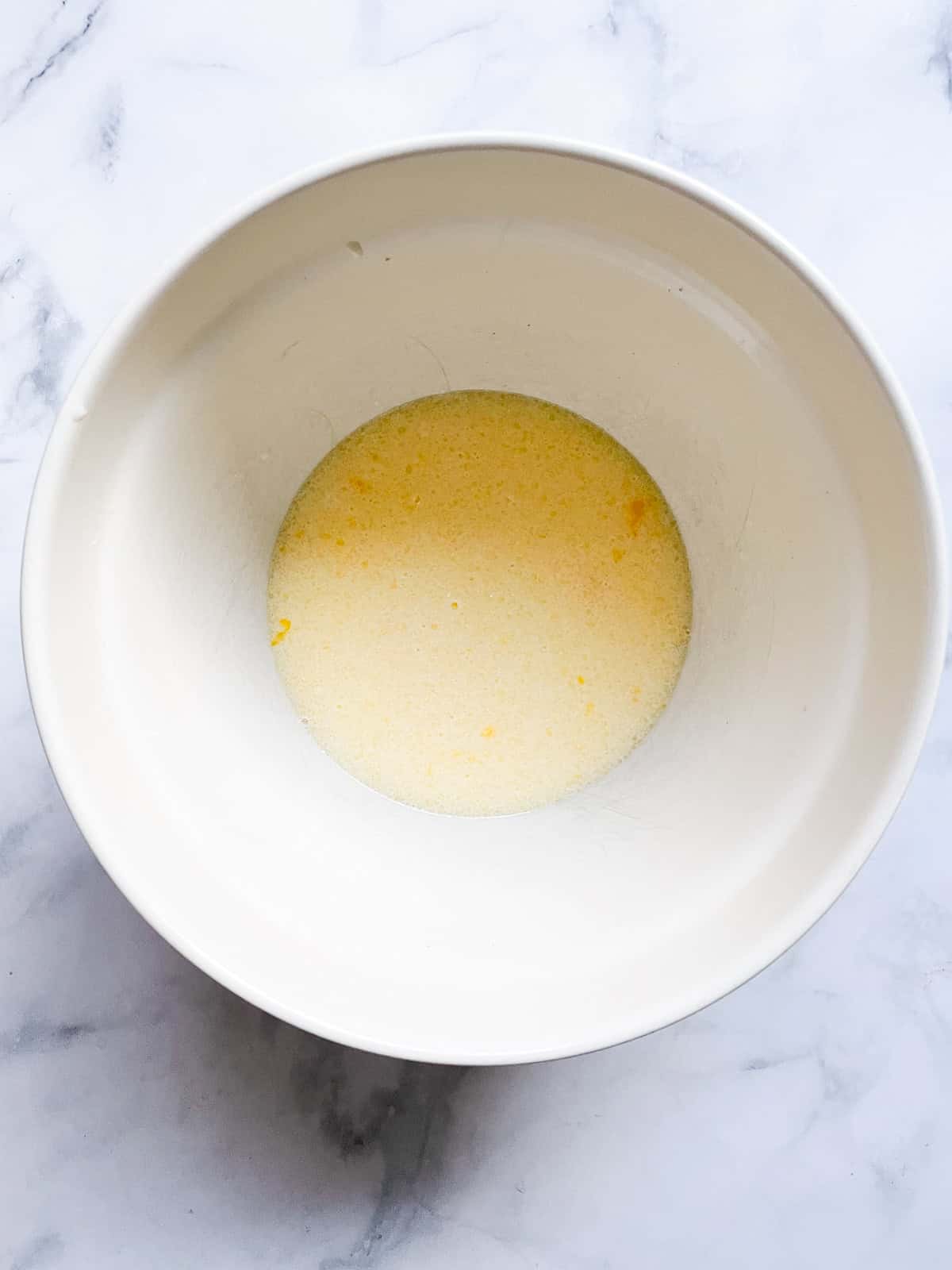 Tender and fluffy oat flour pancakes are made with oat flour for a gorgeous, naturally gluten-free breakfast option. A one-bowl recipe! Wet mix for oat flour pancakes in a bowl.