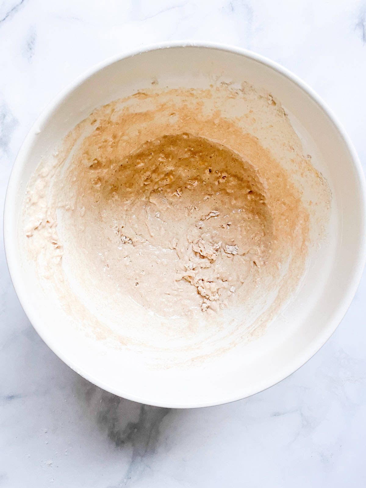 Tender and fluffy oat flour pancakes are made with oat flour for a gorgeous, naturally gluten-free breakfast option. A one-bowl recipe! Batter for oat flour pancakes in a bowl.