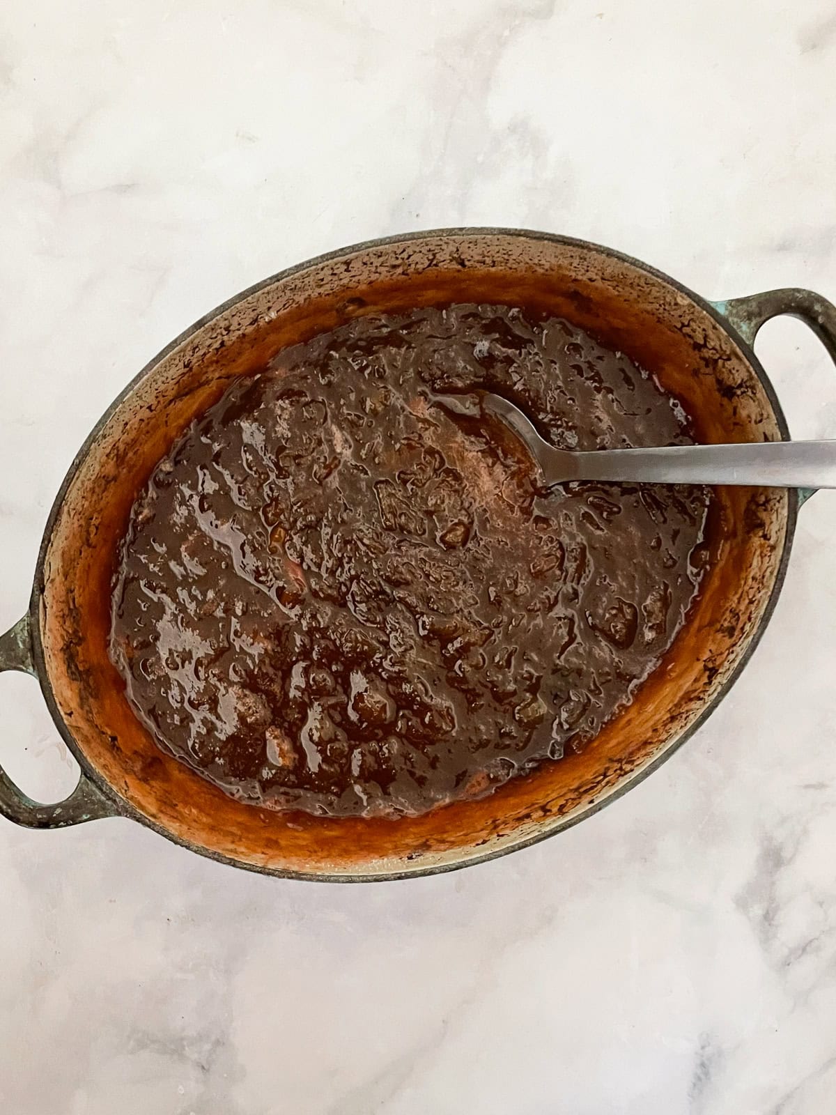 A pot of cooked strawberry & rhubarb jam.
