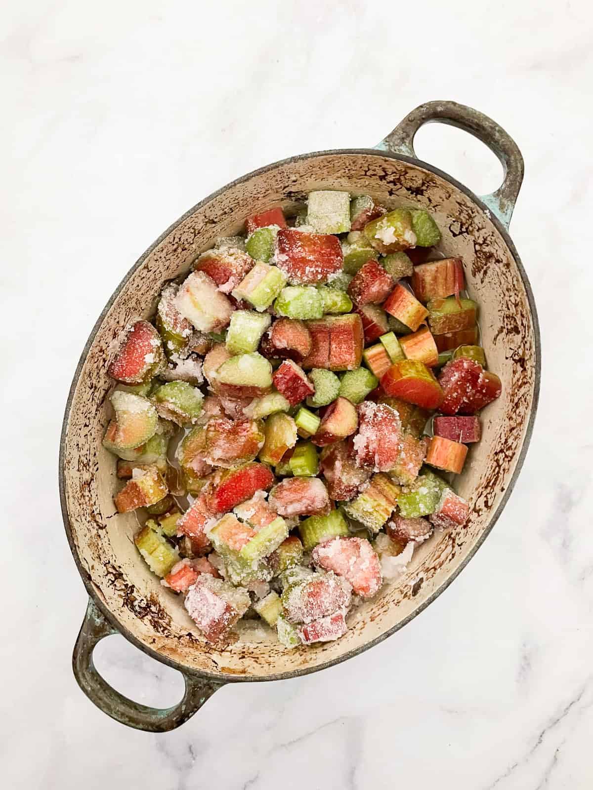 This rhubarb jam recipe produces a tart-sweet jam that mellows on top of a piece of buttered toast or a fresh scone. The ingredients for rhubarb jam are added to a dutch oven.