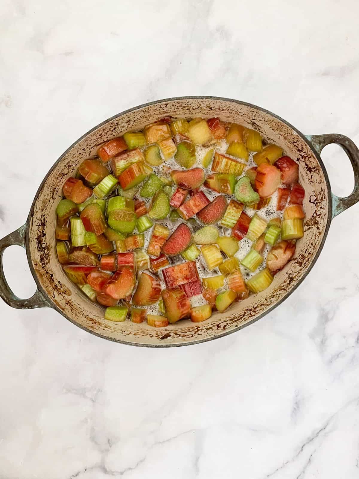 This rhubarb jam recipe produces a tart-sweet jam that mellows on top of a piece of buttered toast or a fresh scone. Rhubarb jam starts cooking in a dutch oven.