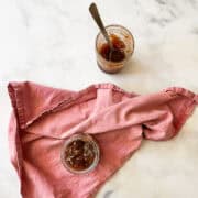 Jars of strawberry & rhubarb jam and a red napkin.