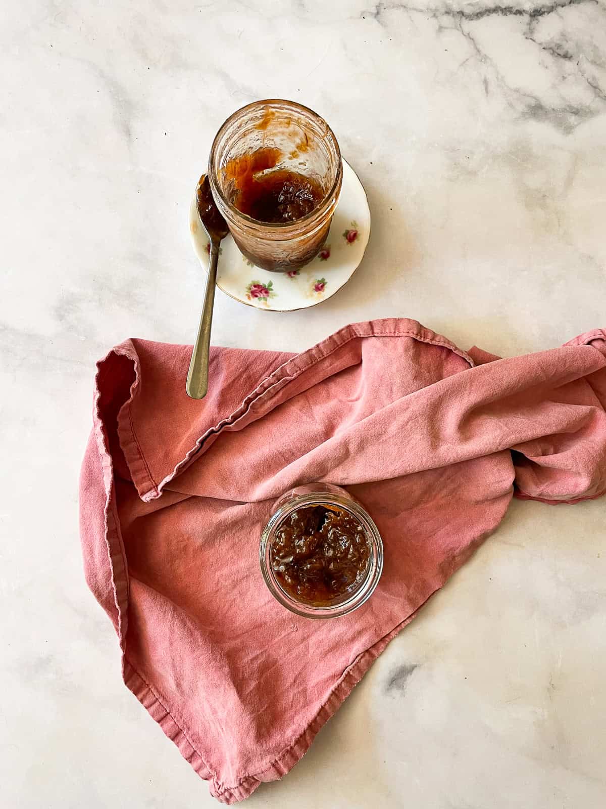Jars of strawberry & rhubarb jam and a red napkin.