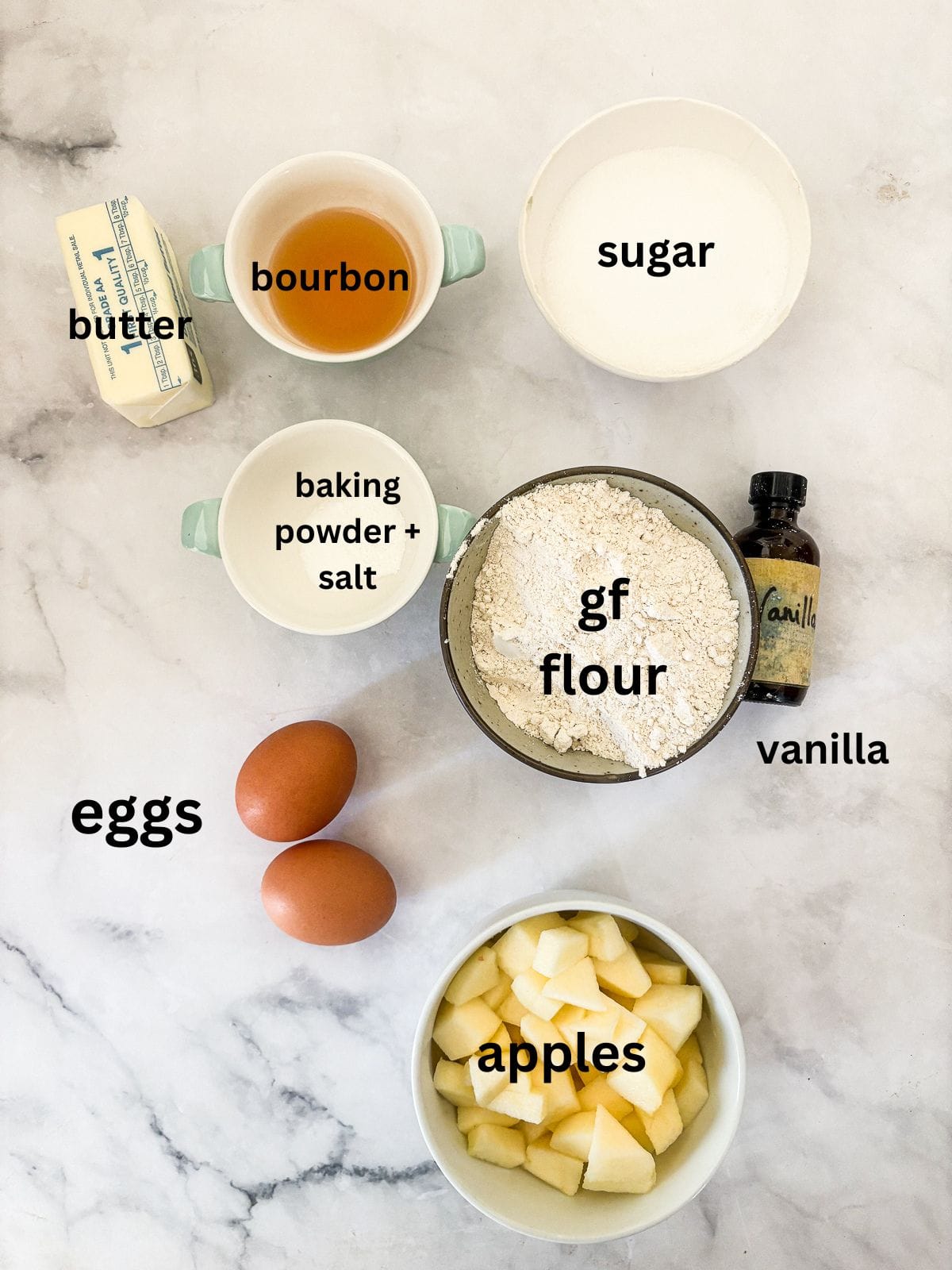 This buttery and tender gluten free French apple cake is inspired by a classic recipe and will almost literally melt in your mouth. Ingredients for gluten free french apple cake are text labeled and portioned.