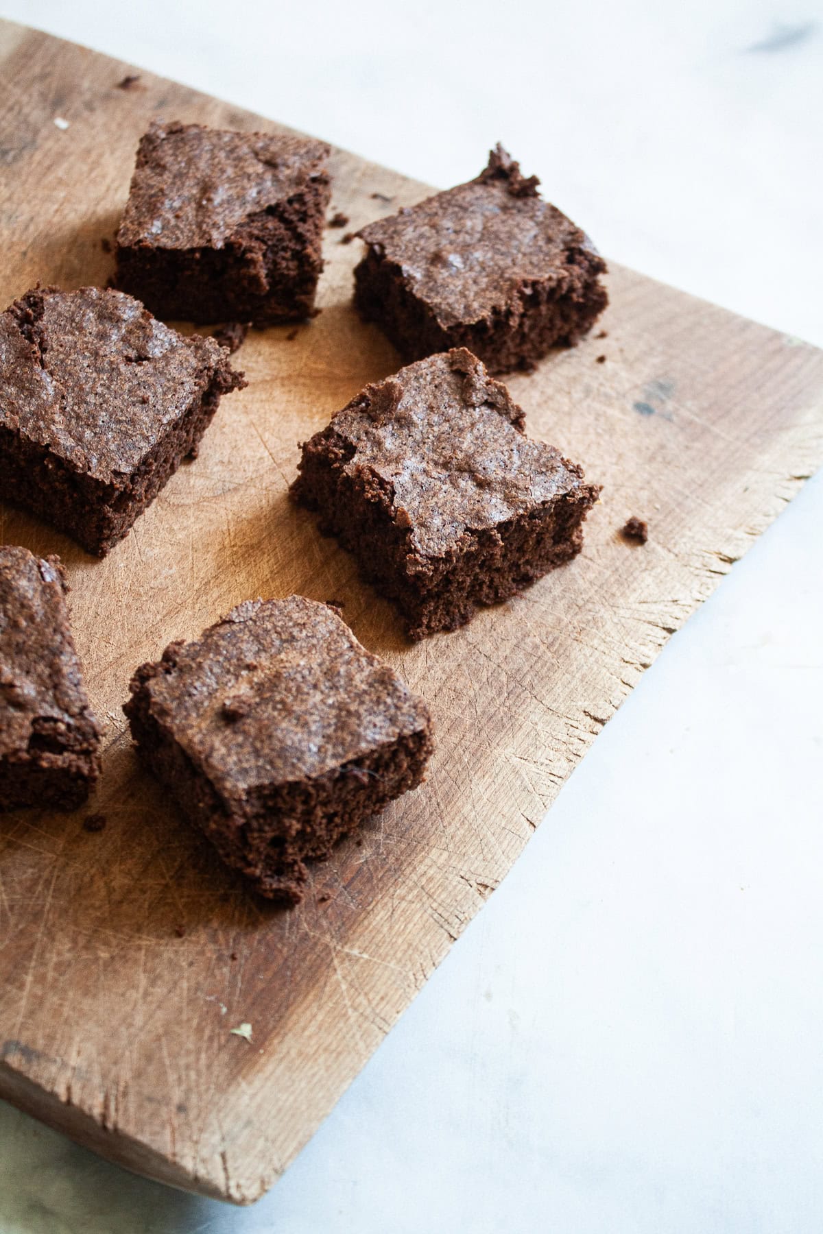 Fudgy gluten free brownies are loaded with chocolatey goodness! Minimal ingredients come together to make the best-ever homemade brownies. Gluten free brownies on a cutting board.