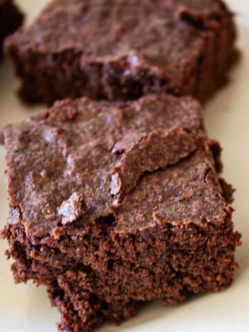Some gluten free brownies on a plate.