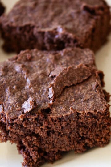 Some gluten free brownies on a plate.