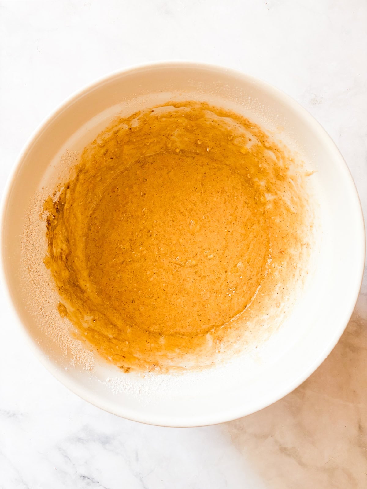 This one-bowl, gluten free easy banana strawberry bread comes together in minutes, and features plenty of chopped fresh strawberries and a kick of cinnamon. Banana strawberry bread batter in a bowl.