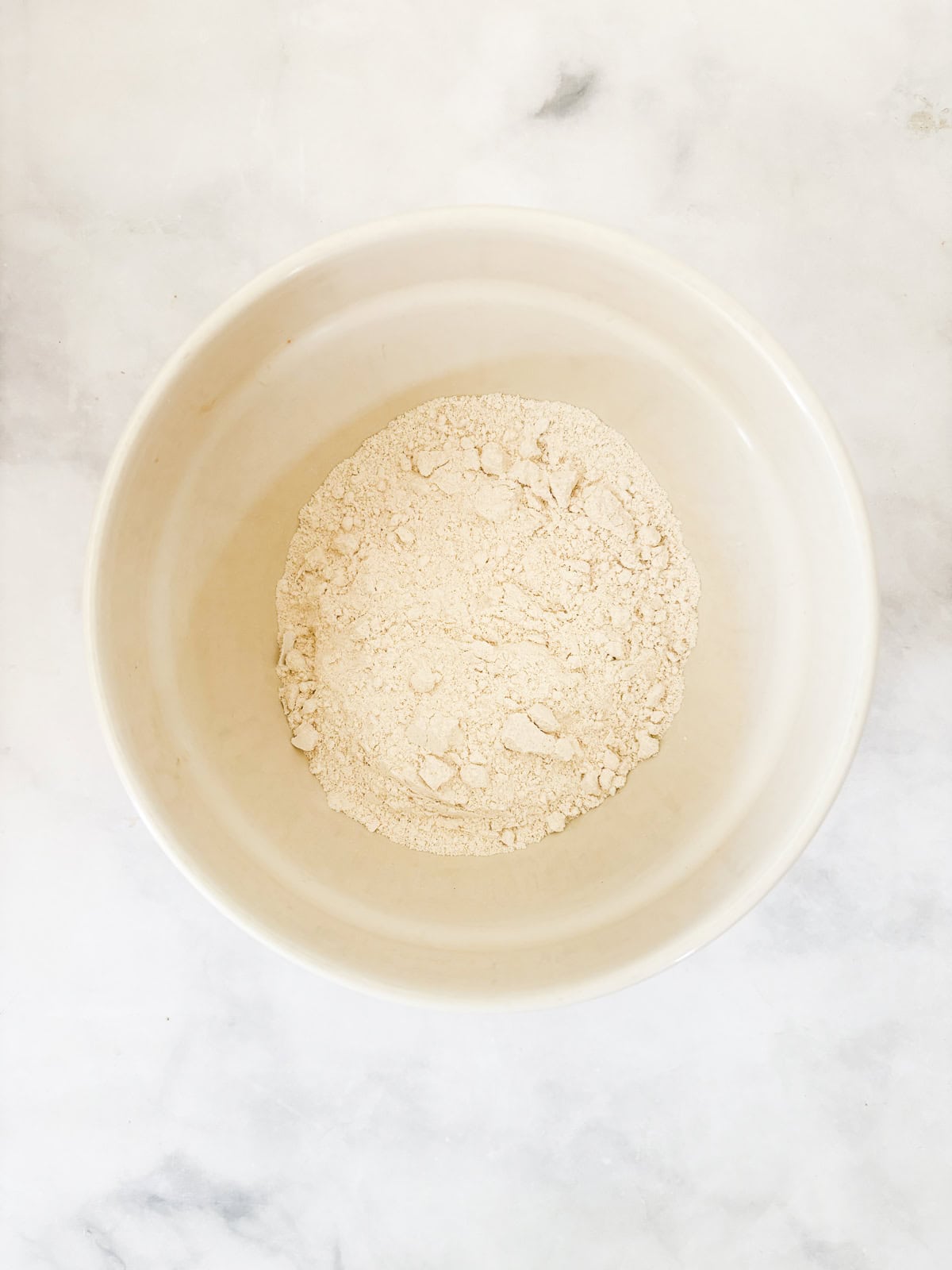 This buttery and tender gluten free French apple cake is inspired by a classic recipe and will almost literally melt in your mouth. The dry mix for french apple cake in a bowl.