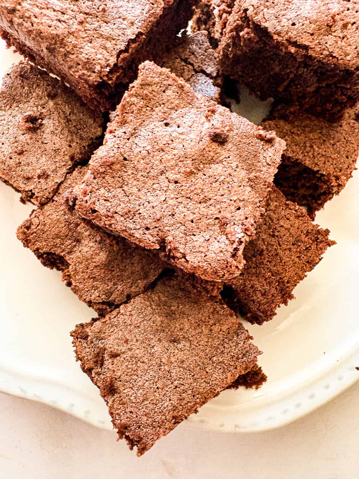 Effortless and gluten-free one bowl brownies are made in, yep, just one bowl. Just mix, pour, and bake to brownie perfection. A close up plate of gluten free one bowl brownies.