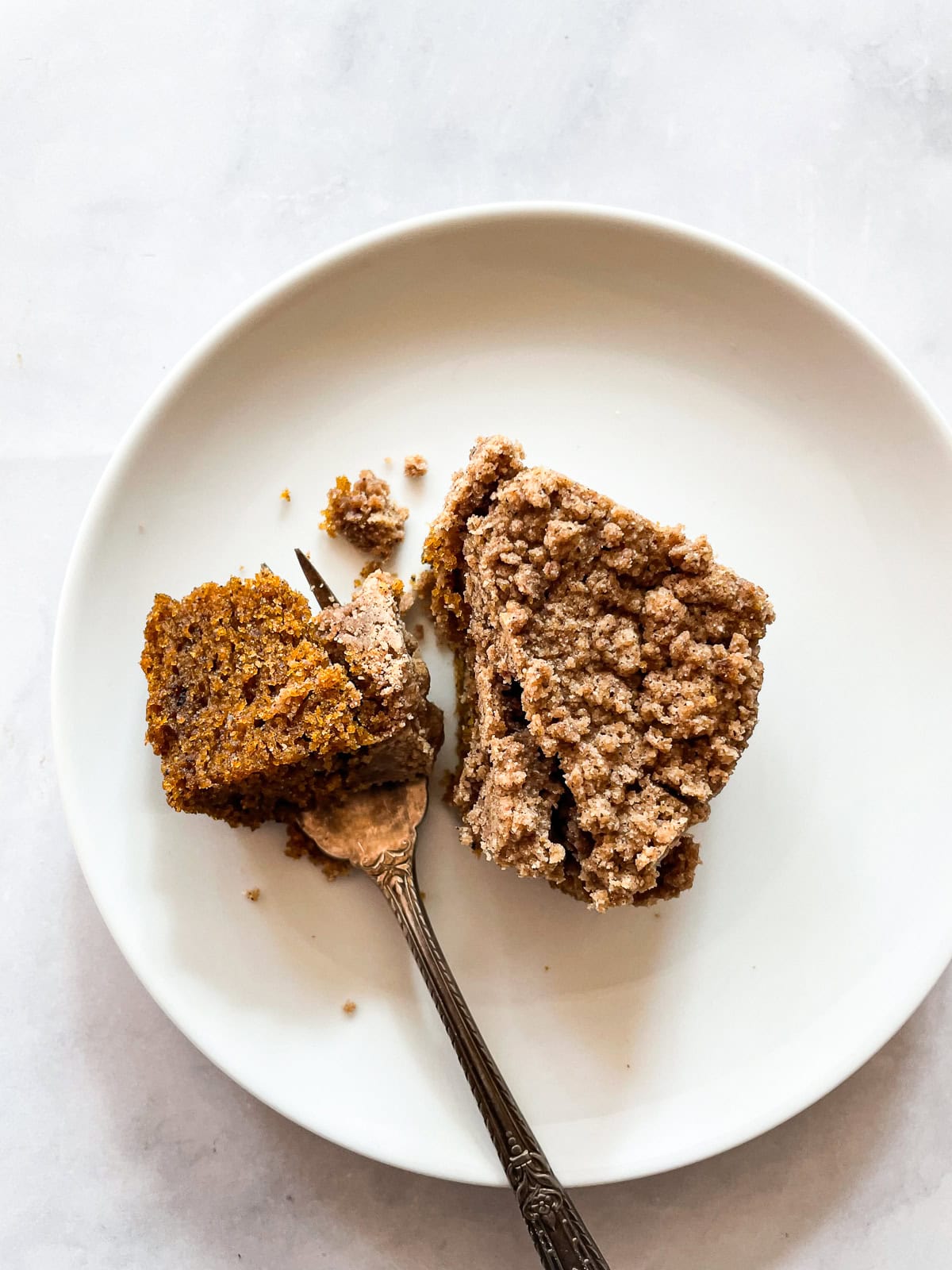 A fork cuts into a piece of gluten free coffee cake.