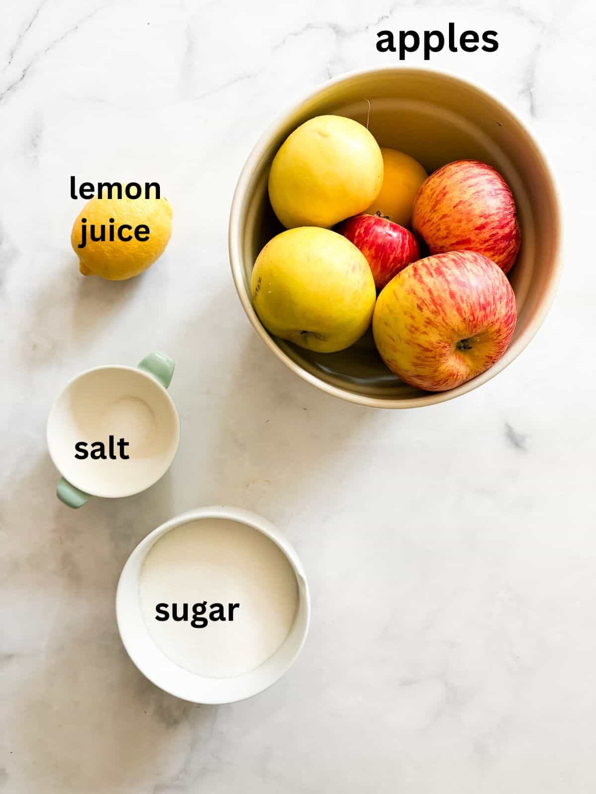 Glossy, sweetly fragrant apple jelly is a special way to make great use of seasonal fruit. Can or refrigerate this beautiful homemade preserve. Ingredients for apple jelly are text labeled.