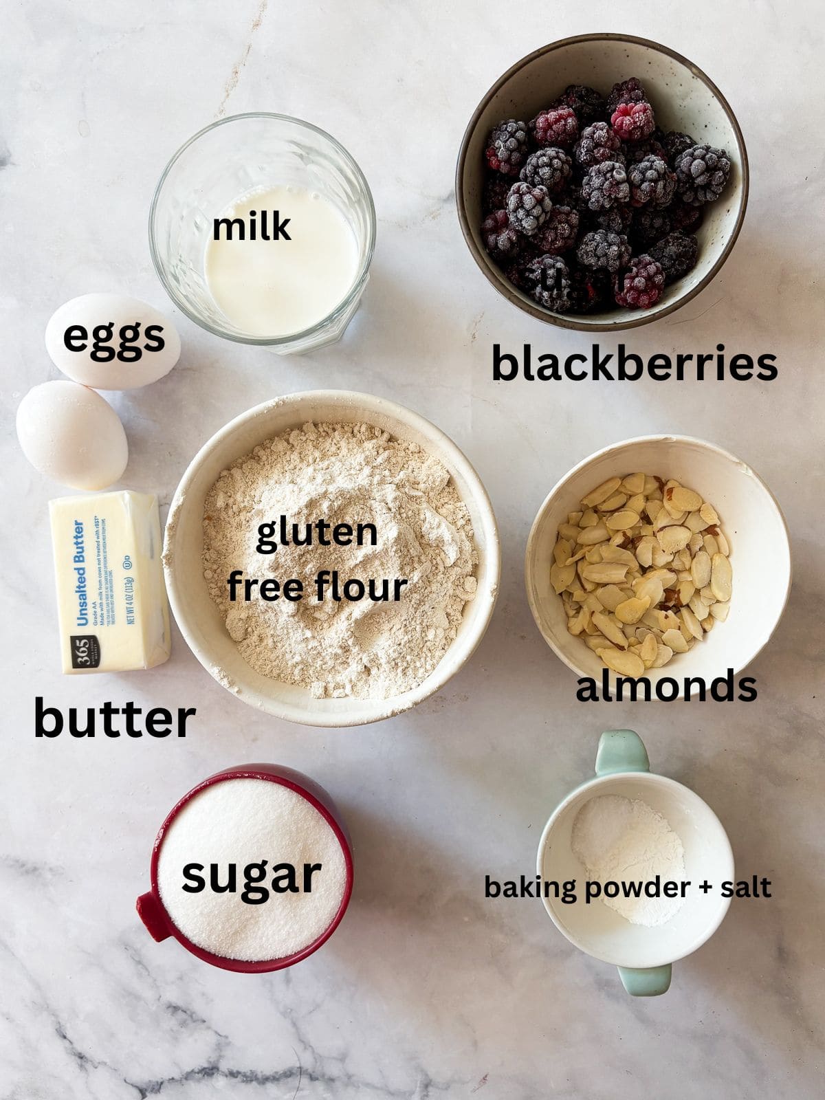 This gluten free blackberry cake features a plush vanilla cake swirled with juicy berries! Delicious and beautiful. Ingredients for gluten free blackberry cake are text-labeled.