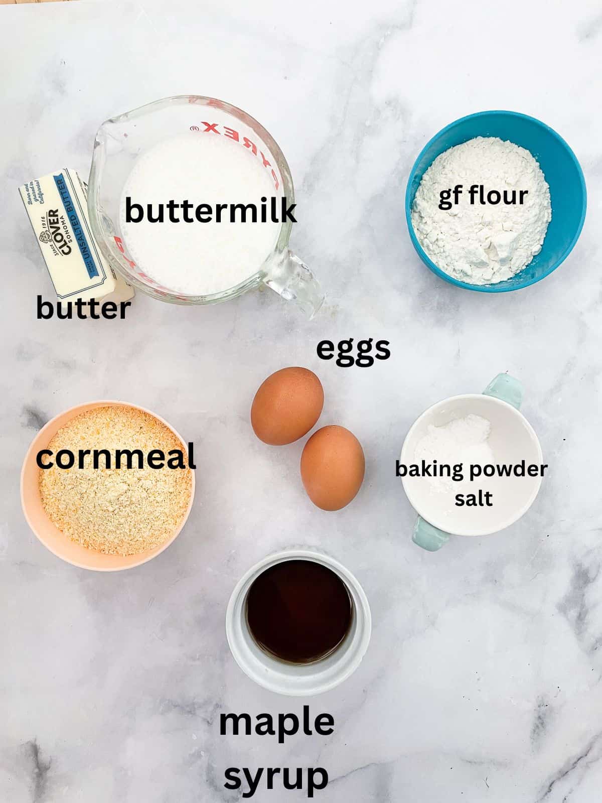 This gluten-free maple cornbread is tender-crumbed perfection thanks to buttermilk. Naturally sweetened with pure maple syrup! Ingredients for gluten free maple cornbread are text-labeled.