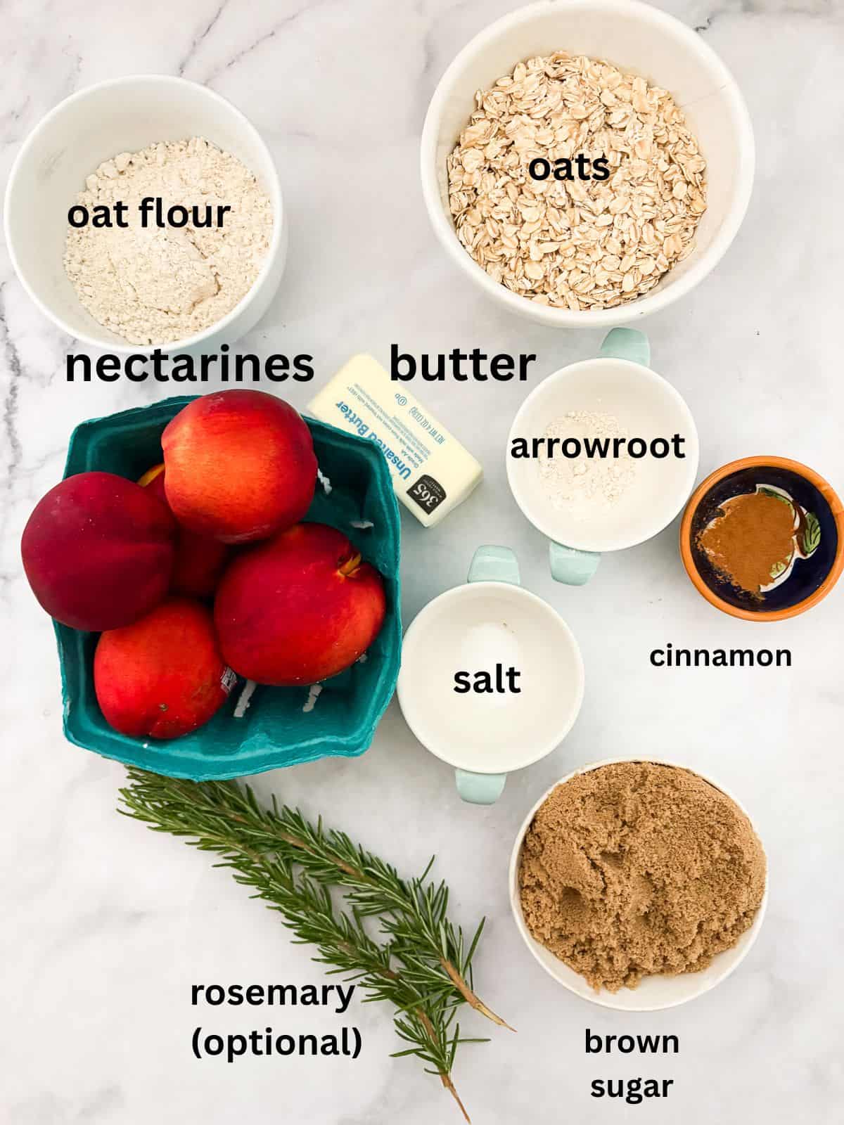 This beautifully simple gluten free nectarine crisp highlights ripe summer stone fruit. Add fresh rosemary for a lovely herbal touch. Ingredients for gluten free nectarine crisp are text labeled and portioned out.