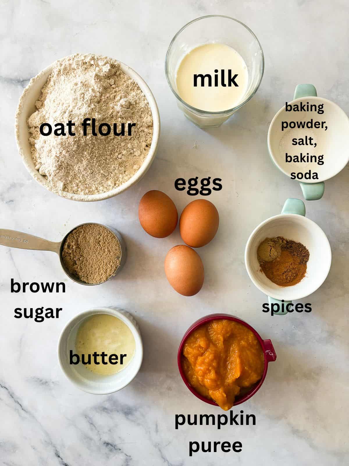 Warmly spiced and naturally gluten-free pumpkin waffles are what you want on a crisp fall morning. Made with whole grain oat flour! Ingredients for gluten free pumpkin waffles are text-labeled.