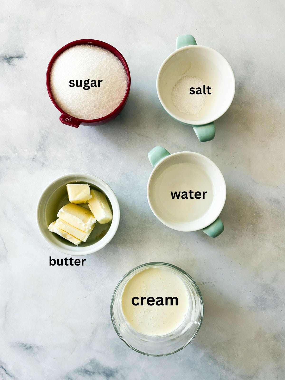 Silky and rich, this homemade salted caramel sauce is an absolute dream. Perfect over ice cream, waffles, cake, pancakes, and more. Ingredients for salted caramel sauce are text-labeled.